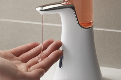 A Close Up View of A Hand Using The Clearasil Perfectawash Device